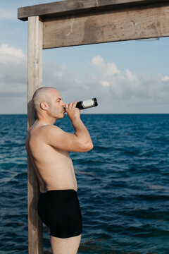 Man Drinking Beer on Pier