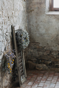 Wild flowers grown in old barn on a shutter