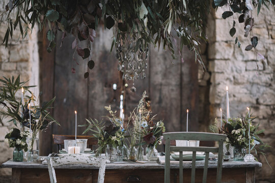 Table decorated for wedding inside an old barn