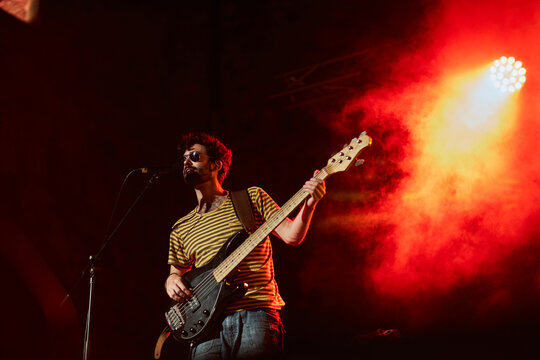 Young musician playing the bass in a live concert