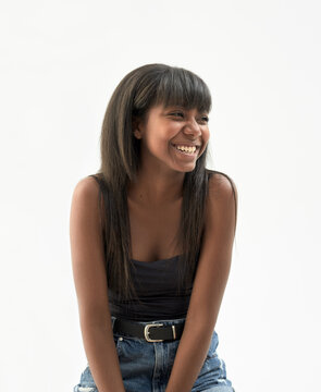 Portrait of young black woman smiling with plain white background