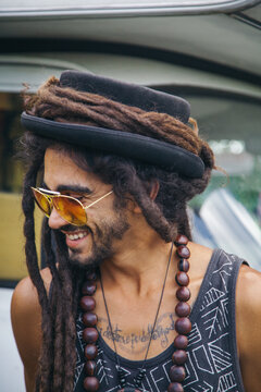 Portrait Of A Young Cheerful Man With Dreadlocks