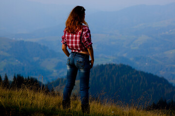 Fototapeta premium girl in a stylish men's shirt and blue jeans
