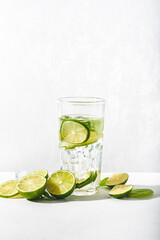 Drink glasses with water ,lime,mint and ice on white background