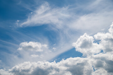 Cloudy sky. White cold clouds against the blue sky. Natural landscape background.