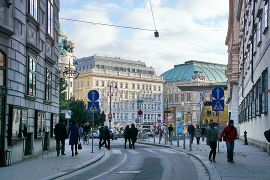 People walking in front of Vienna State Opera, named Wiener Staatsoper in Deutsch, Austrian opera house on Albertinaplatz in Vienna, Austria
