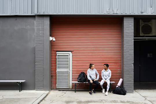Two female athletes having conversation.
