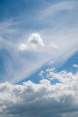 Cloudy sky. White clouds fly across the blue sky. Natural landscape background.