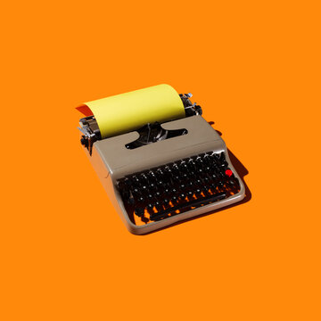Typewriter on Orange Backdrop