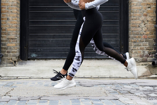 Details of fit runner legs rythmic on the street.