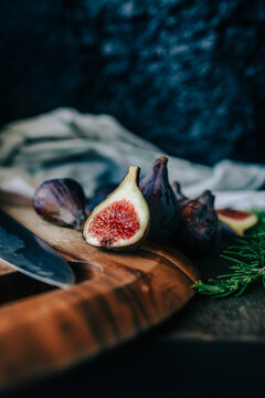 Fresh cut open fig on a cutting board.