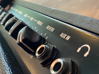 Close-up reverb and black knob of modern amplifier and control panel. clean and hi-gain distortion...
