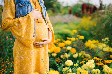 Pregnant woman standing in garden