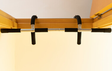 bottom view of a pull-up bar set in a doorway