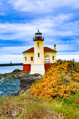 Fototapeta na wymiar Bandon lighthouse with gorsch blossoms on the Coquille river and the Oregon coast at Bandon