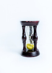 vertical photo of a dark wood hourglass. stoves are yellow. there are scuffs on the tree