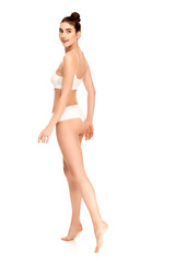 Fototapeta premium barefoot woman with perfect body looking away and walking on white