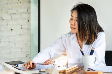 Real Estate business interior architect professional teamwork design sale meeting new normal yellow safety helmet with beautiful Asian female woman Team with happy smile success contract