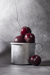Ripe plum in a glass. Wet purple plum