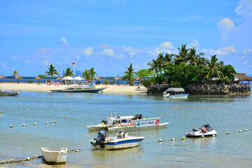 Fototapeta na wymiar Cebu White Sands beach resort with boats in Cebu, Philippines
