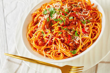 spaghetti with pork vegetable ragout in a bowl