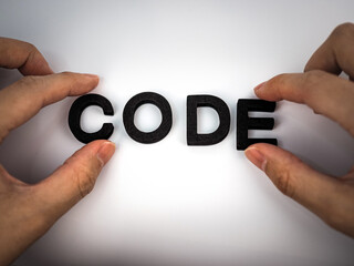 Code text with hands holding letter