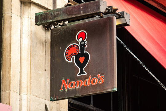 London- Nandos logo on exterior signage, a popular grilled chicken high street restaurant 