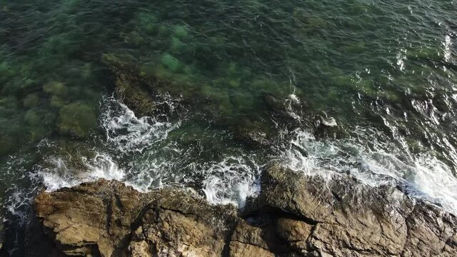 Bird's Eye View Zoom Out, Sea Waves And Stone Beach Aerial View Drone Shot.
