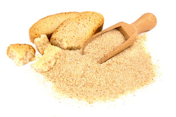 Pile of breadcrumbs and spoon isolated on white