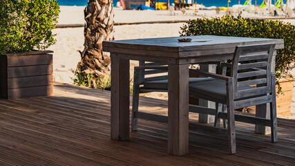 set of table and chairs at the beach