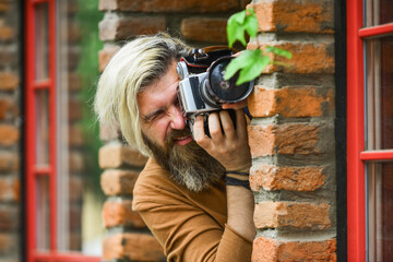 private detective. SLR camera. hipster man with beard use professional camera. photographer hold...