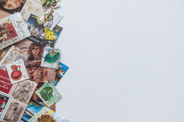 Composition of stamps scattered on a white background. Ukrainian stamps. Copy space.