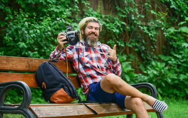 Photographer use vintage camera. Bearded man hipster taking photo. Man with retro camera. Camera settings concept. Find perfect angle. Photography in modern life. Hobby and professional occupation