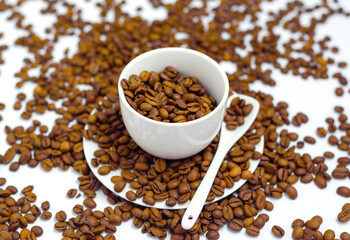 white coffee Cup and coffee beans on a white background, the concept of cheerfulness