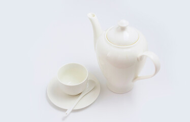 white Cup with plate and teapot on a white background