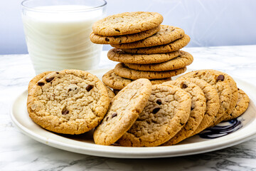 Chocolate chip cookies on a plate with milk. Calgary, Alberta, Canada