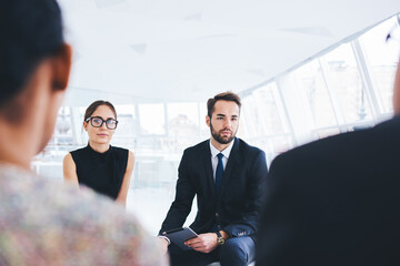 Young professionals dressed in office outfit interviewing in finance company for improving skills...