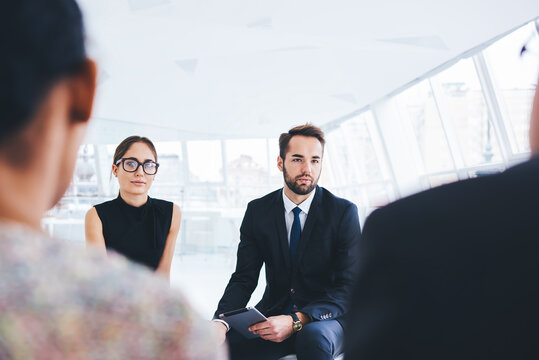 Young professionals dressed in office outfit interviewing in finance company for improving skills and increased training. Successful business people discussing commercial project with new partners