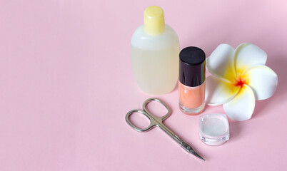 nail polish scissors rub for manicure and a flower on a pink gray background, nail care manikure and pedicure at home or in a spa salon procedures	