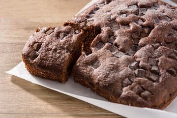 Sweet chocolate sponge cake on wooden table.	