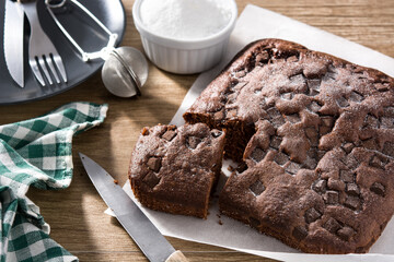 Sweet chocolate sponge cake on wooden table.	