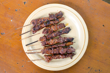 Beef satay with peanut sauce, indonesian skewer cuisine