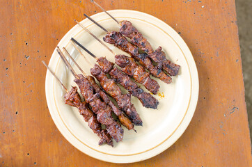 Beef satay with peanut sauce, indonesian skewer cuisine