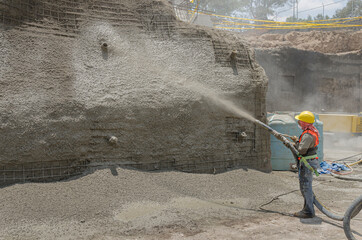 Concrete pumping hose used to cover with cement a construction wall 
Cement applied with high...