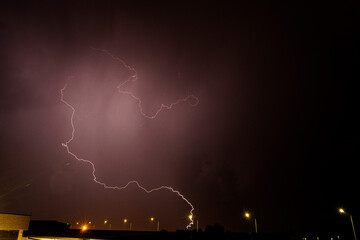 lightning falling at night during a thunderstorm