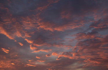 The sunset sky is blue-purple with bright clouds