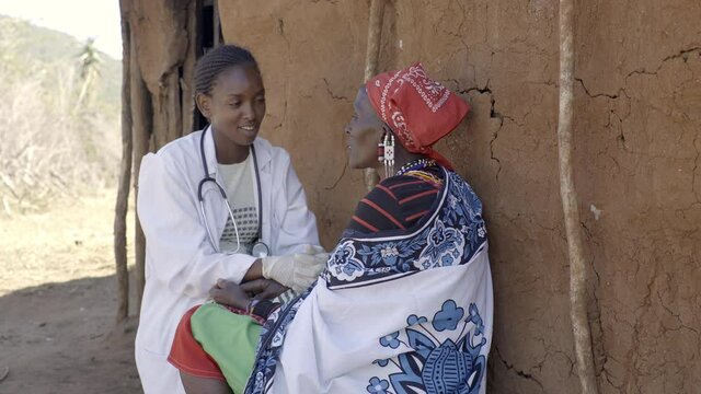 Female Doctor Examining Patient In Rural Community,  Kenya, Africa