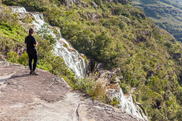 Girl looking a huge waterfall at Guartela Canyon, sixth largest canyon in the world in length - Tibagi/ Parana - Brazil