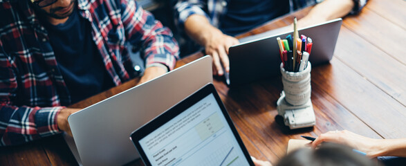 Group of young people working together. Creative business people in modern office. Hipster team in coworking. Young modern colleagues.