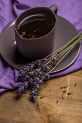 Obraz na płótnie Canvas Cup of lavender tea and lavender flowers. Organic lavender tea.